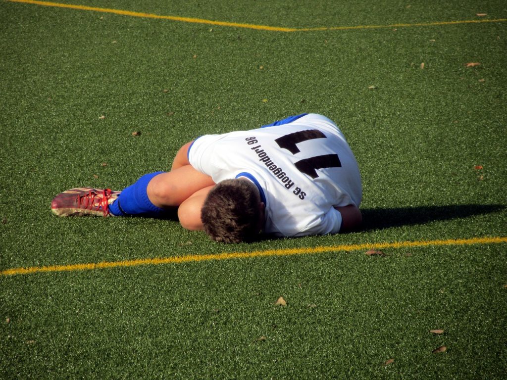 soccer player injured on the ground