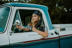 hippie teen driving a classic truck