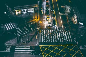 Busy intersection with cars and pedestrians