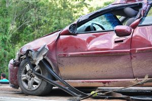 red car smashed on the drivers side