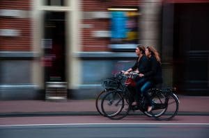 blurry image of women riding bikes