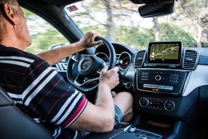 man driving and using GPS