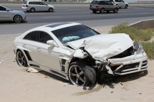 car collision on the side of the road in sand